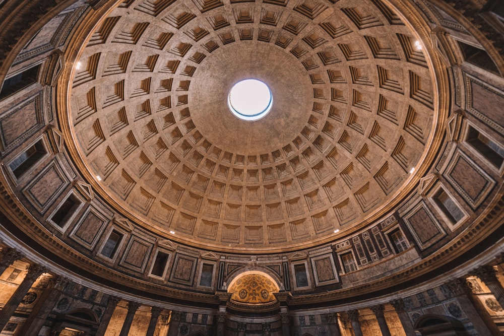 a tall glass building with Pantheon, Rome in the background