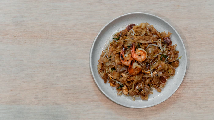 Pad See Ew — wide flat noodles stir-fried with greens