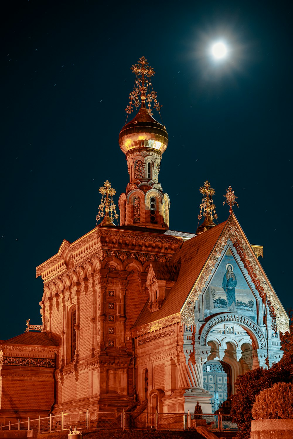 a church with a clock tower lit up at night