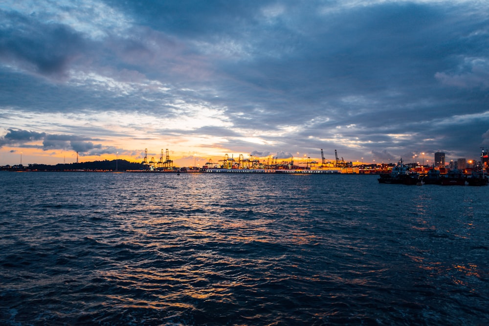 a large body of water with a city in the background