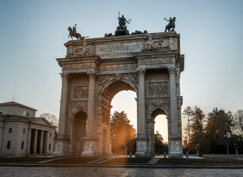 a stone arch with statues on top of it