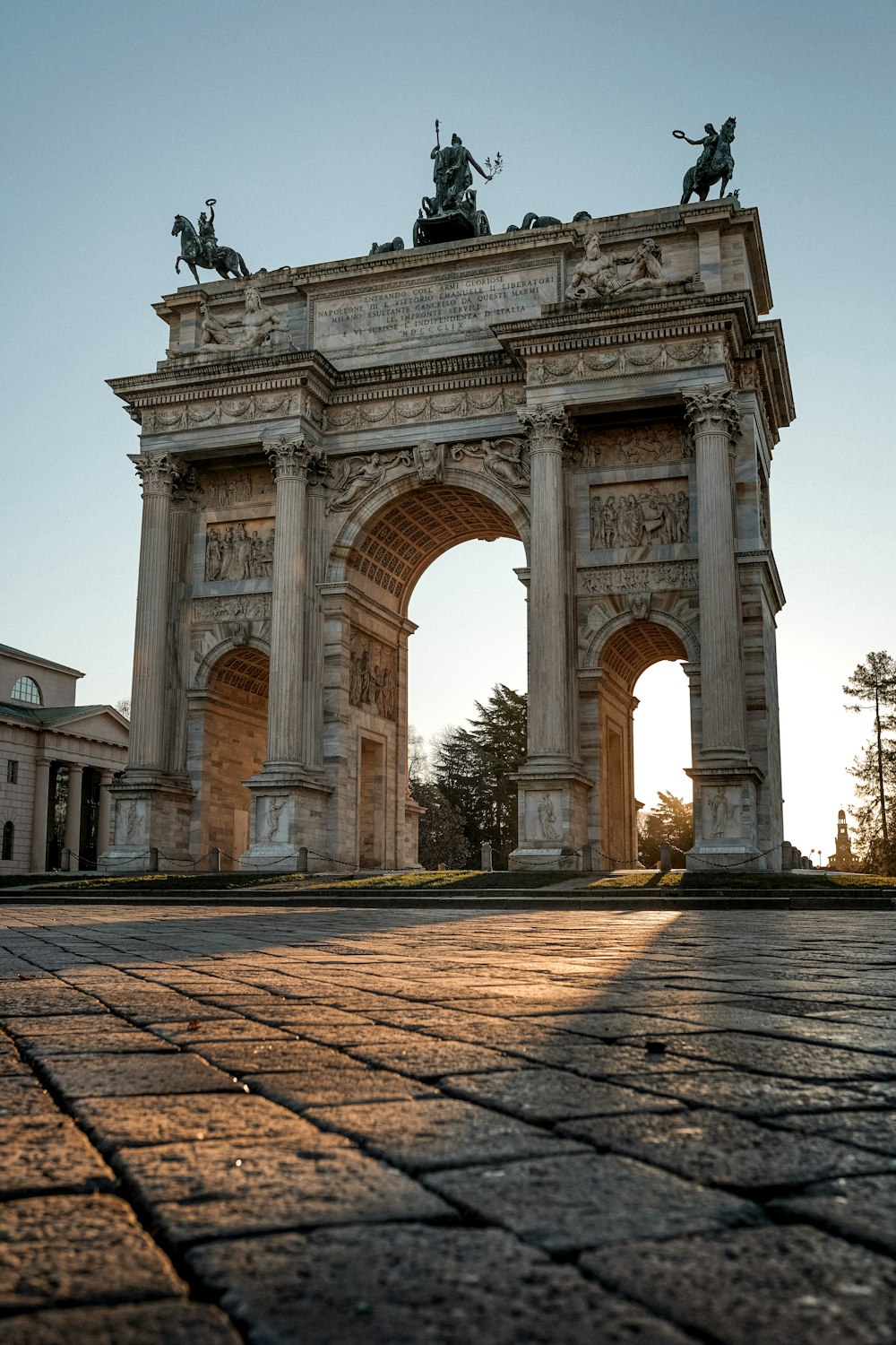 a stone arch with statues on top of it