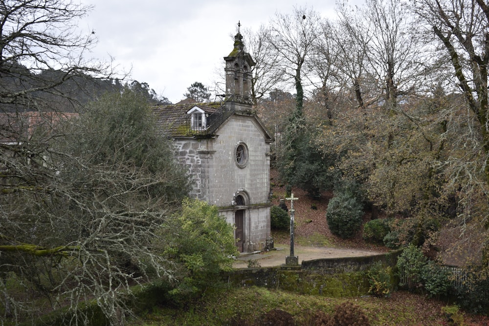 an old church in the middle of a wooded area