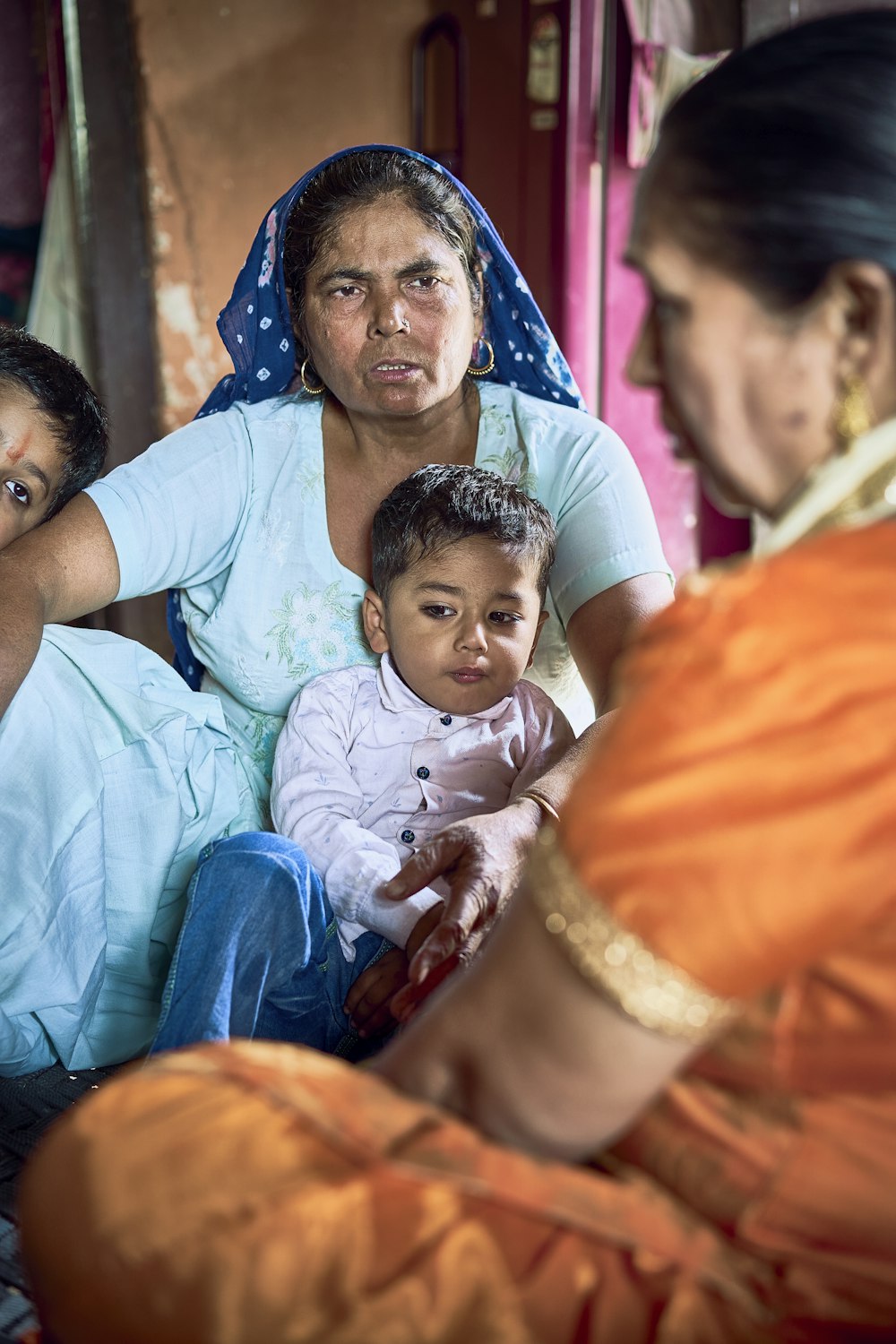 a group of people sitting around a baby