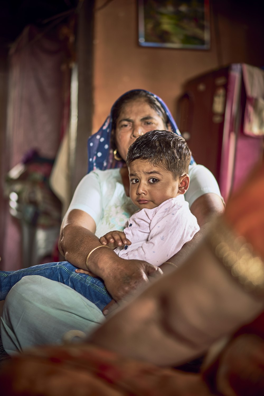 a woman holding a child in her lap