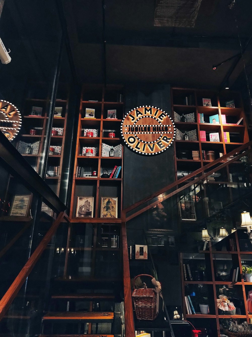 a bookshelf filled with lots of books in a room