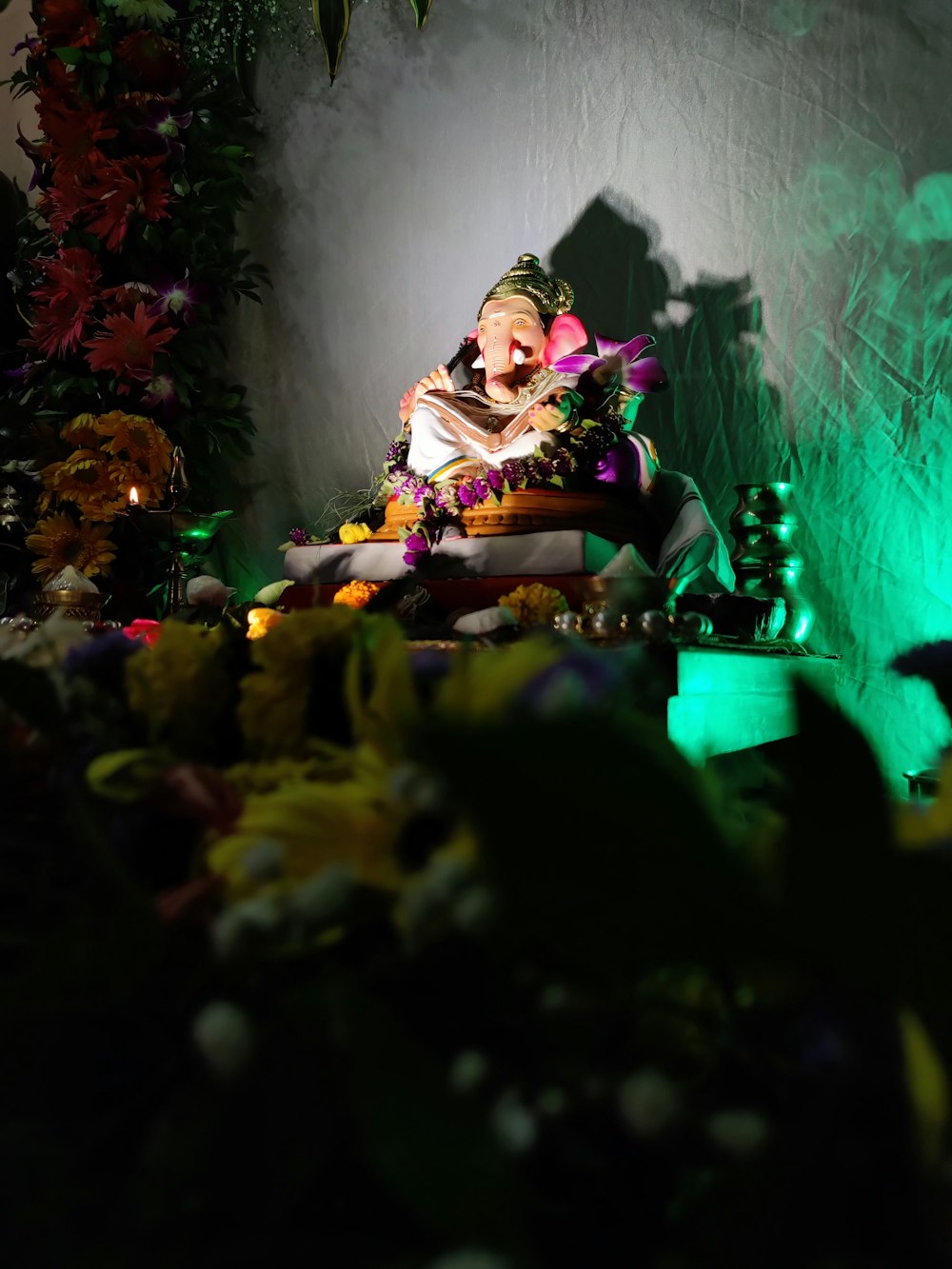 a man sitting in a chair surrounded by flowers