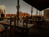 Weather-resistant outdoor dining set under soft evening light on a wooden deck.