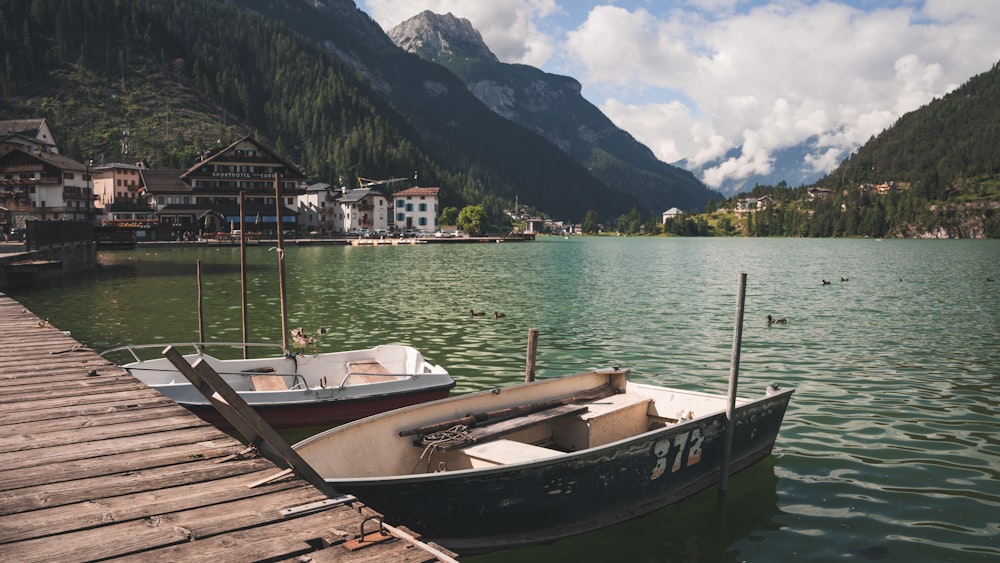 a boat is docked at a pier on a lake