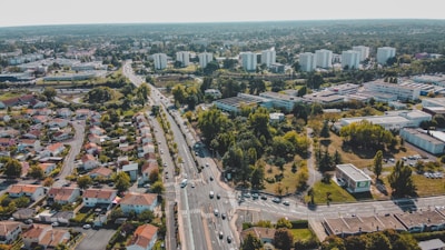 Aerial view of a modern residential subdivision with green spaces and roads.