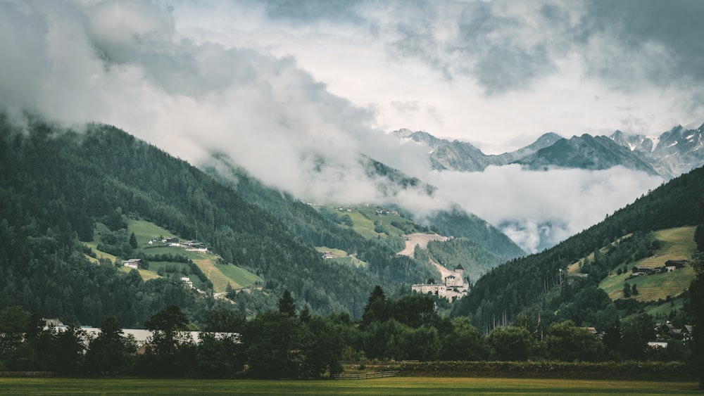 a view of a mountain range covered in clouds