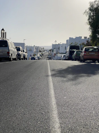 A busy Riyadh street with freshly painted road markings under bright sunlight.