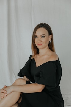 a woman in a black dress posing for a picture