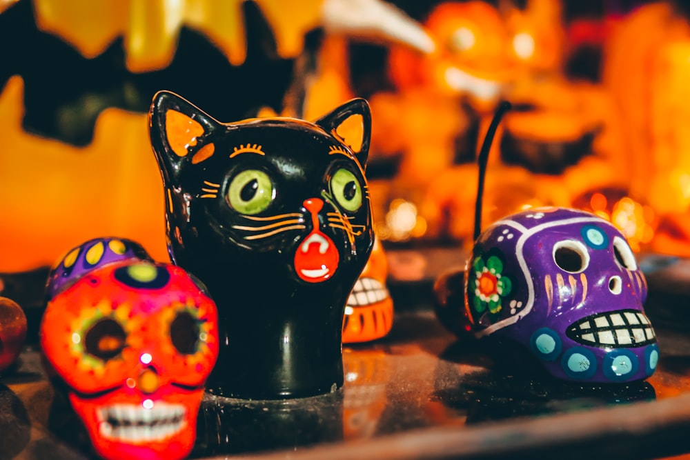 a close up of a table with skulls and cats