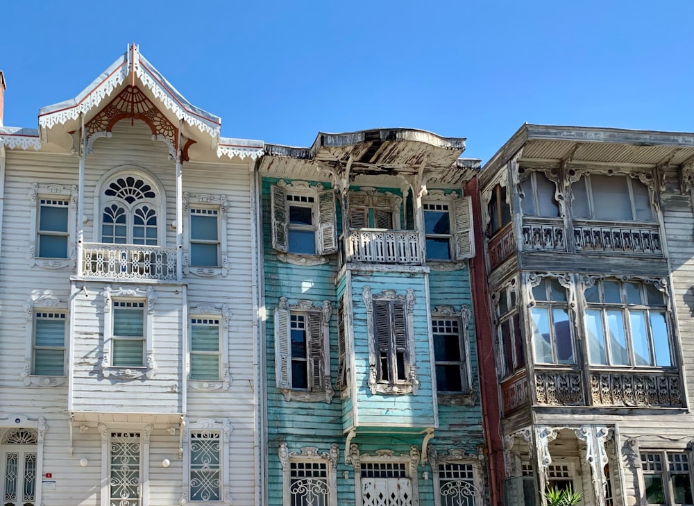 a row of multicolored wooden houses with balconies