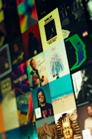 A collage of album covers with dark blue, grey, and red color highlights arranged neatly on a black background.