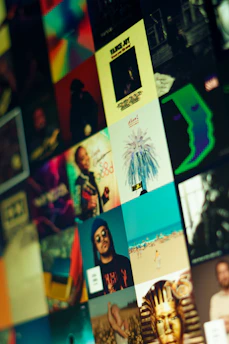 A collage of album covers with dark blue, grey, and red color highlights arranged neatly on a black background.