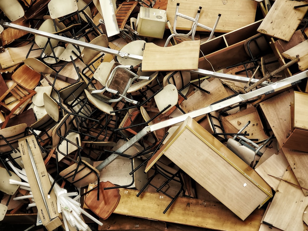 a pile of wooden chairs and chairs sitting on top of each other