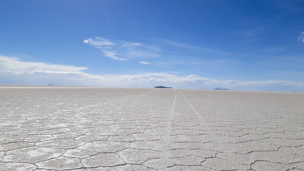 a barren area with a blue sky in the background