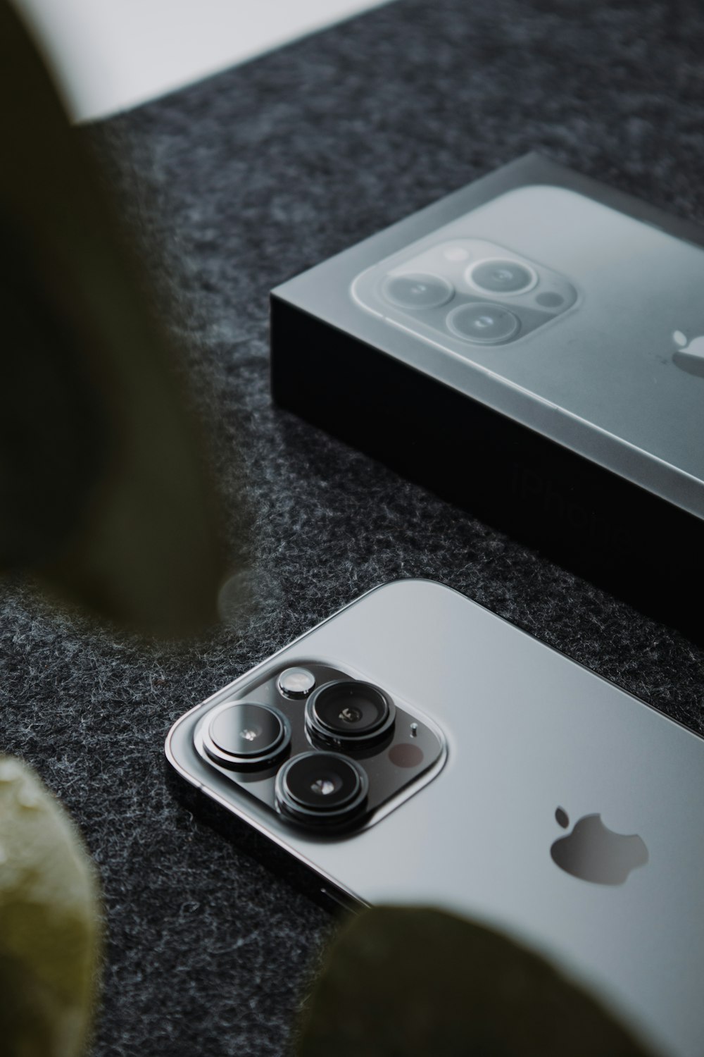 a close up of two cell phones on a table