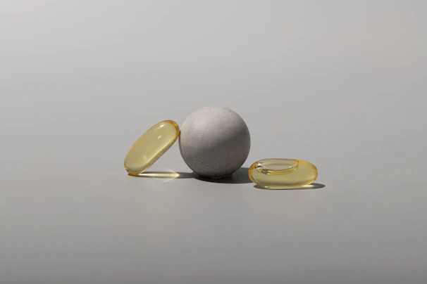 Elegant composition of softgel capsules in soft natural light, emphasizing their glossy texture and purity.