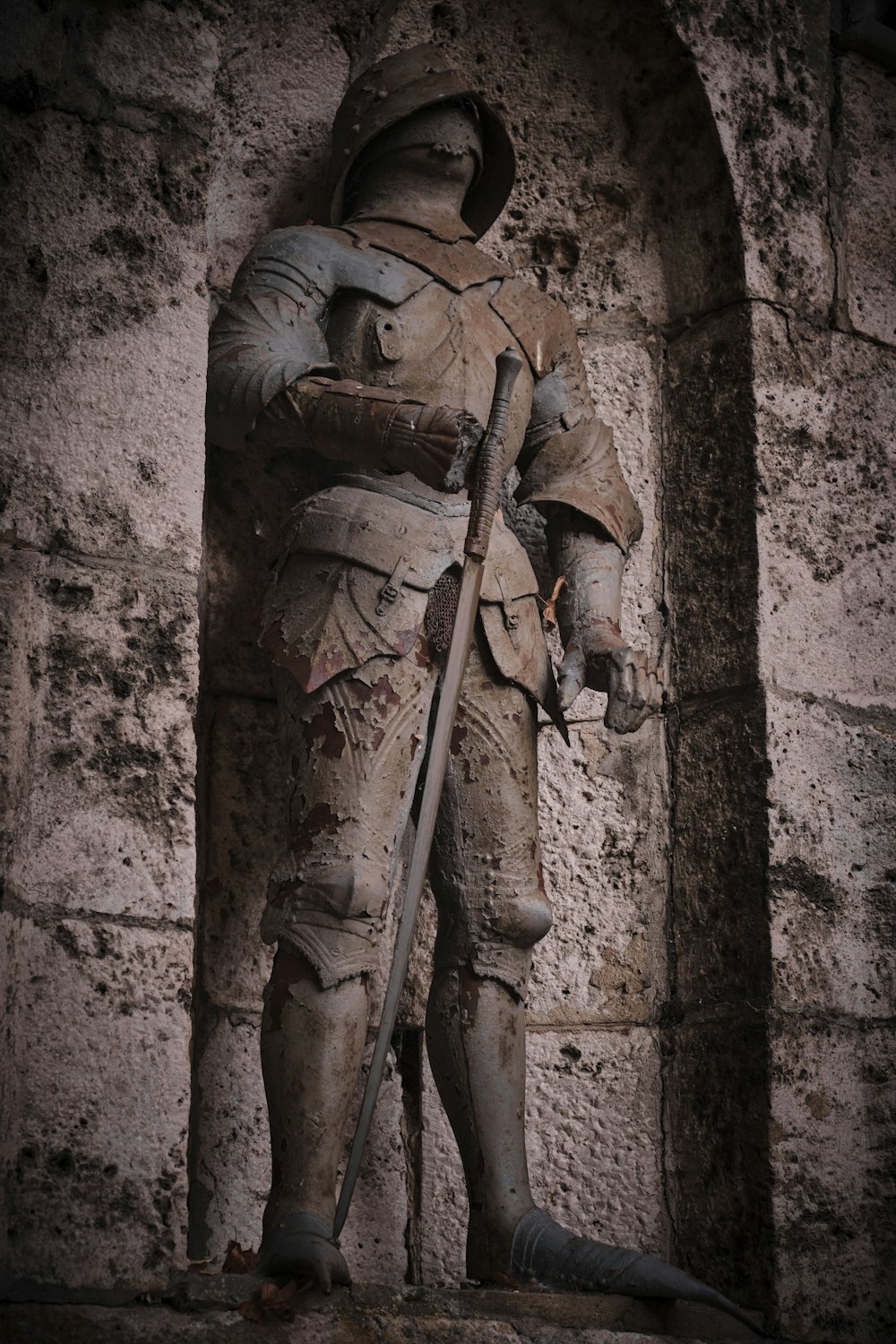 a statue of a man holding a sword