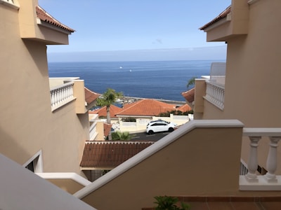 A scenic view of Tenerife coastline with a welcoming home in the foreground.