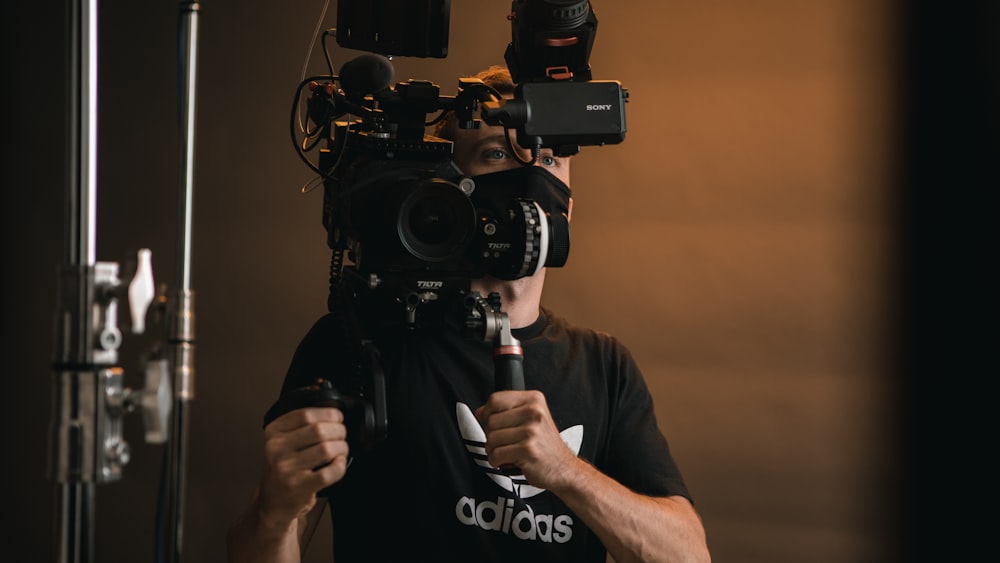 a man holding a camera in front of his face