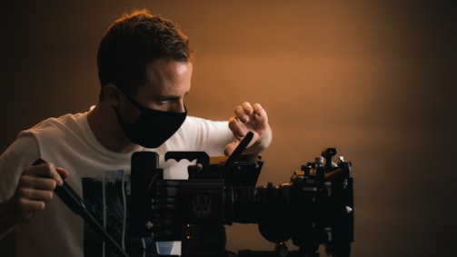 a man wearing a face mask and holding a camera