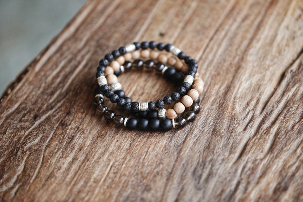 a couple of bracelets sitting on top of a wooden table