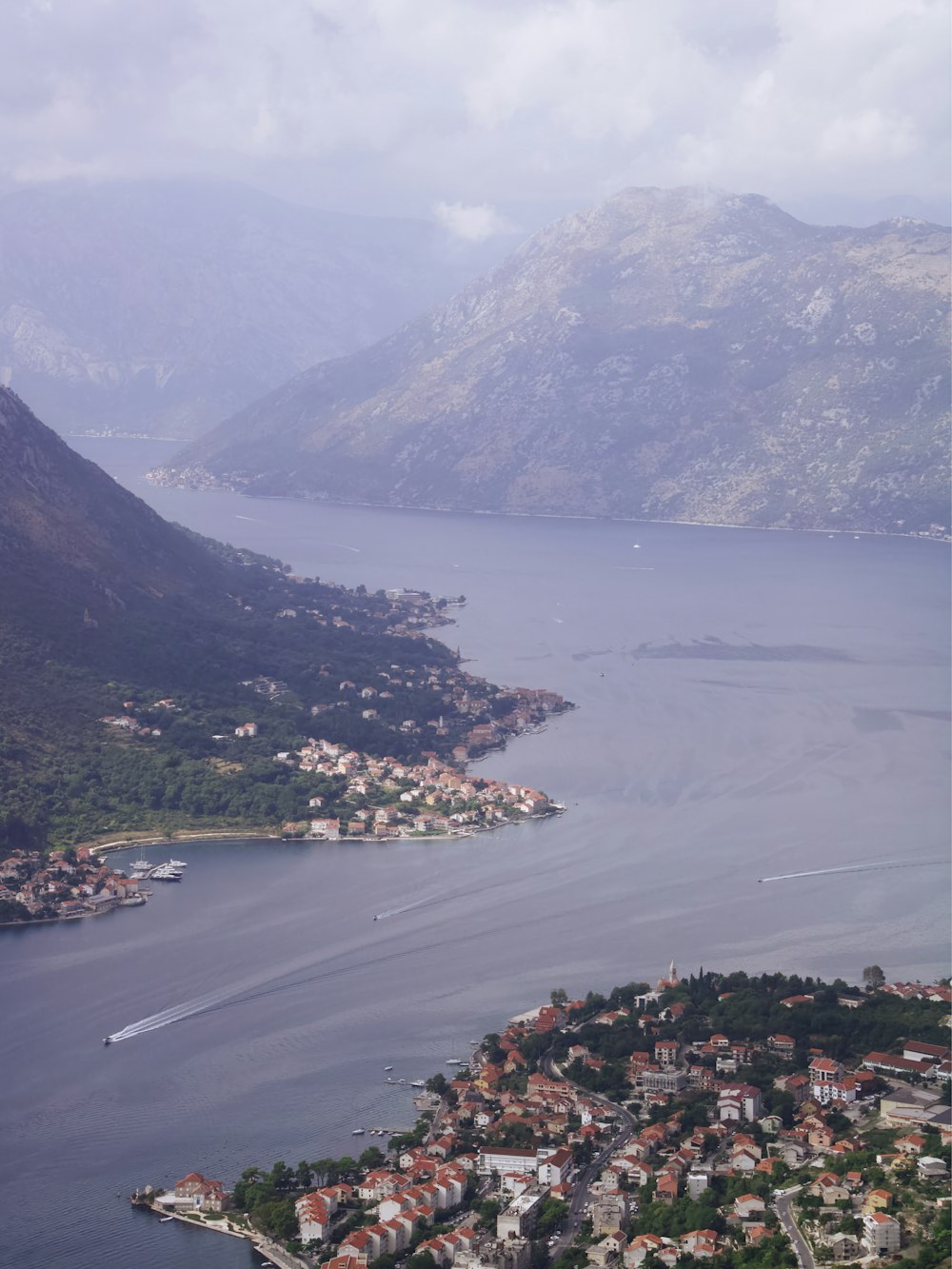 an aerial view of a town and a body of water