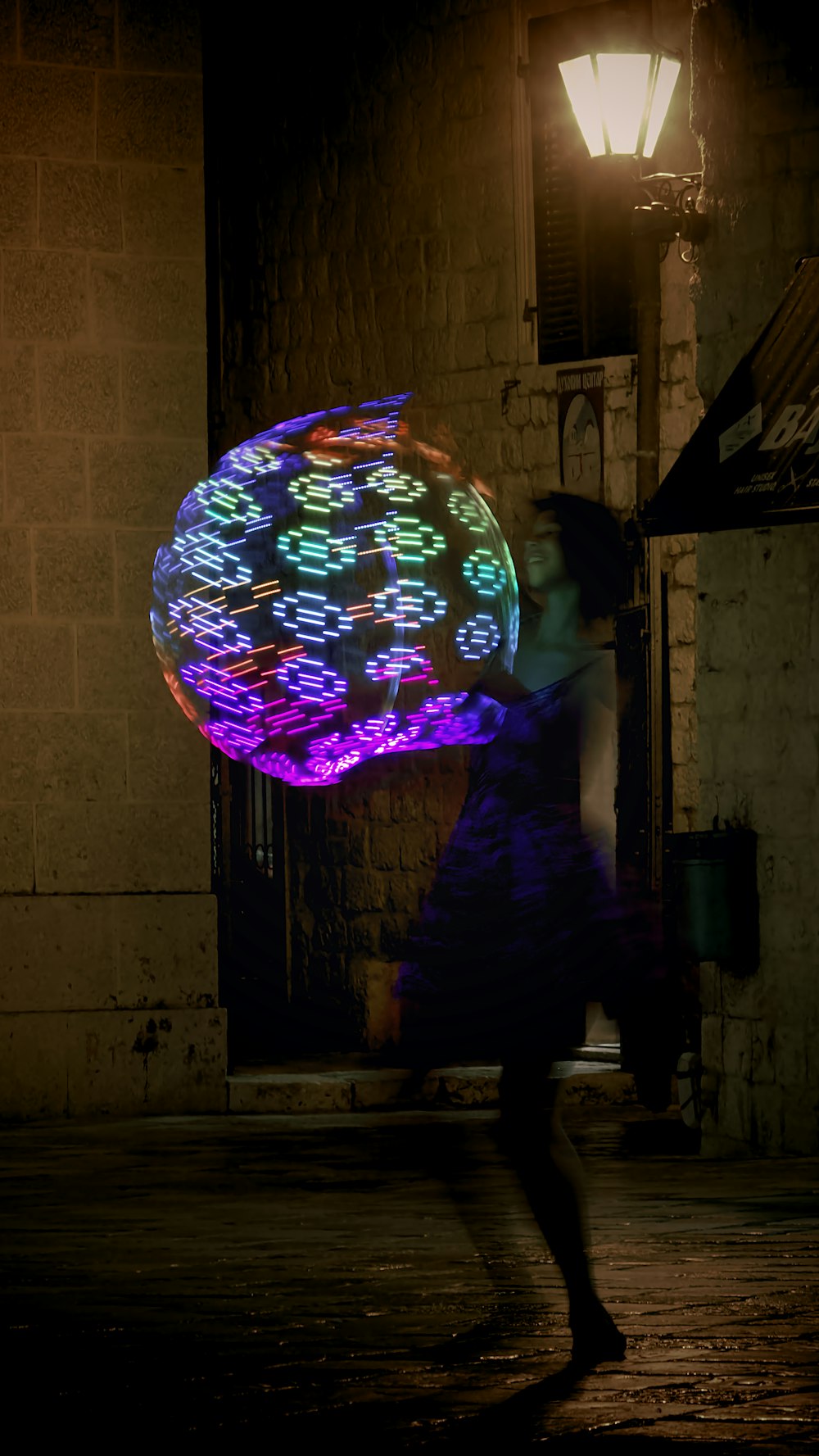 a woman is holding a glowing object in the dark