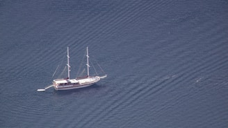 a sailboat floating in the middle of a body of water