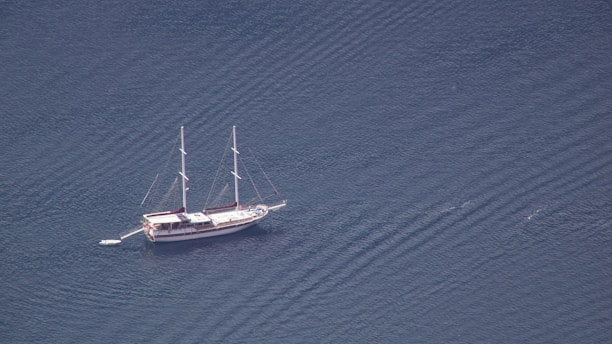 a sailboat floating in the middle of a body of water