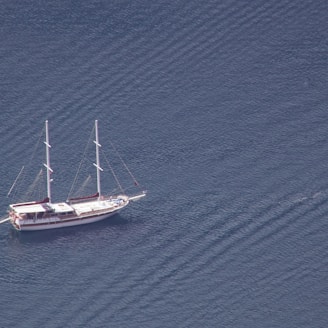 a sailboat floating in the middle of a body of water