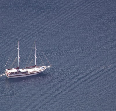 a sailboat floating in the middle of a body of water