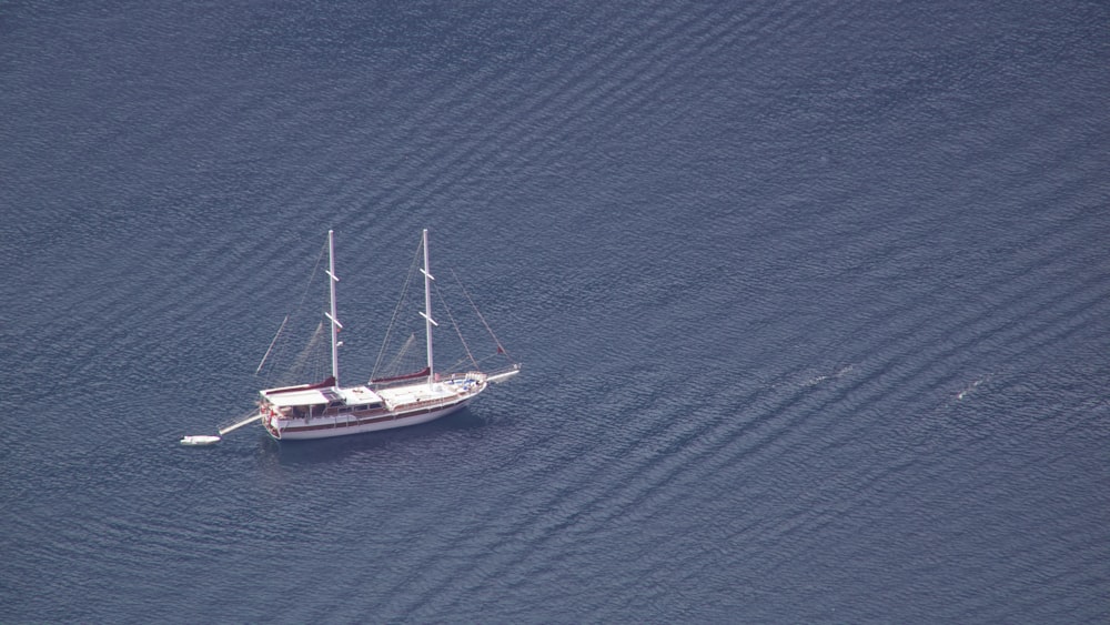 a sailboat floating in the middle of a body of water