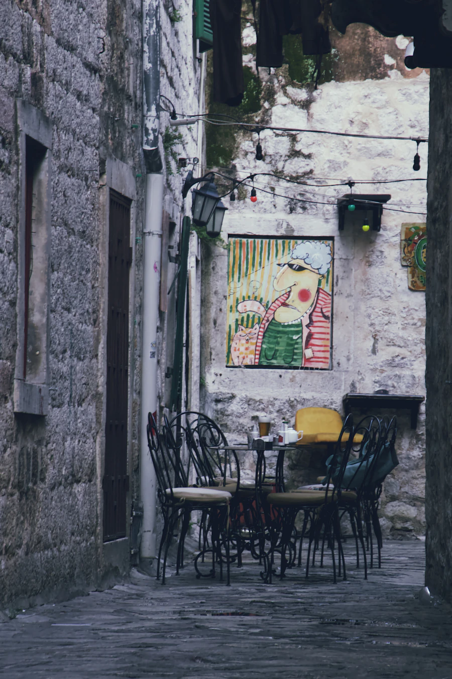 Kotor eski şehrinde taş bir sokakta açık hava kafesi