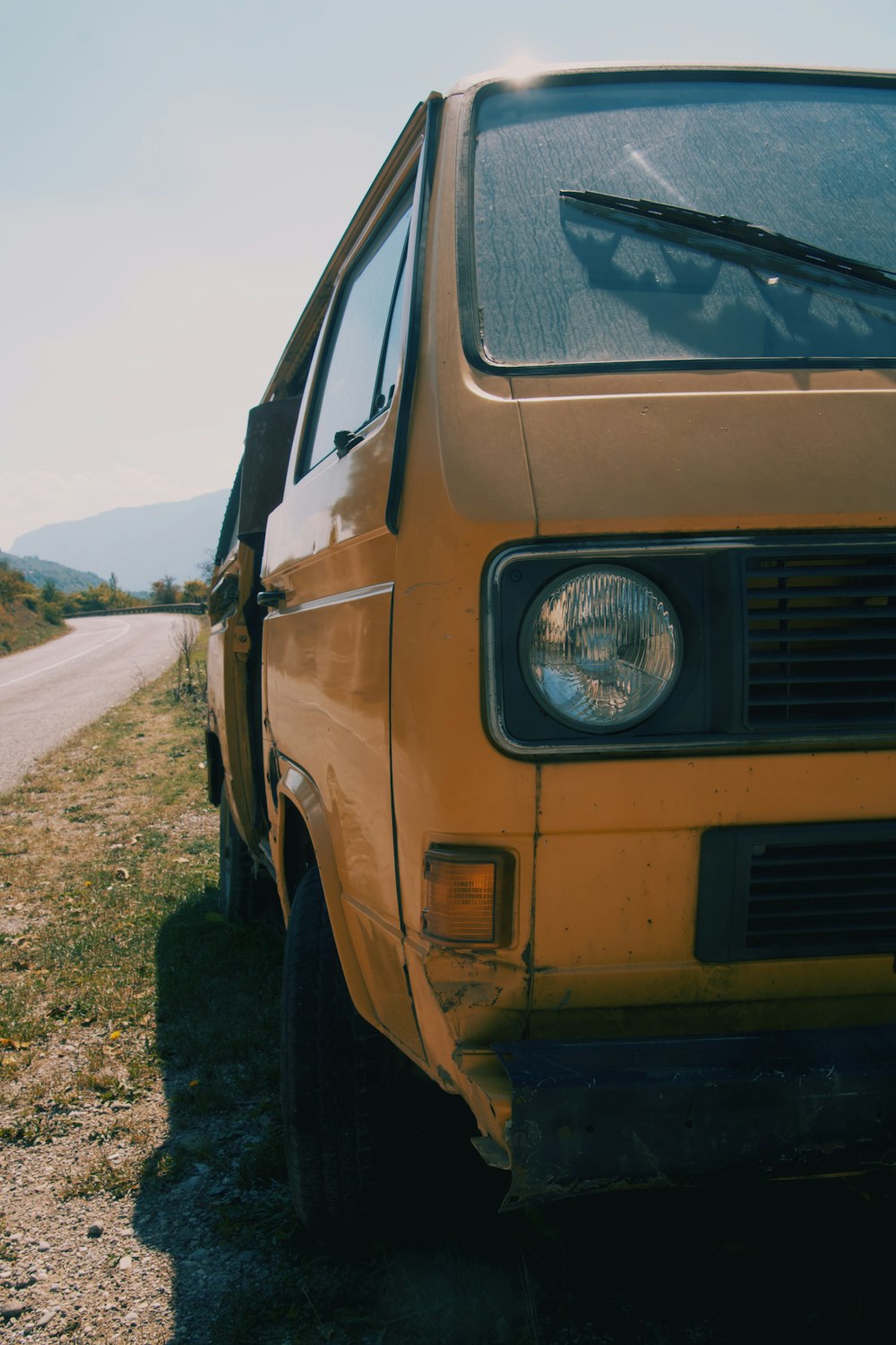 a yellow van parked on the side of a road