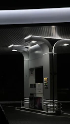 a gas station at night with lights on