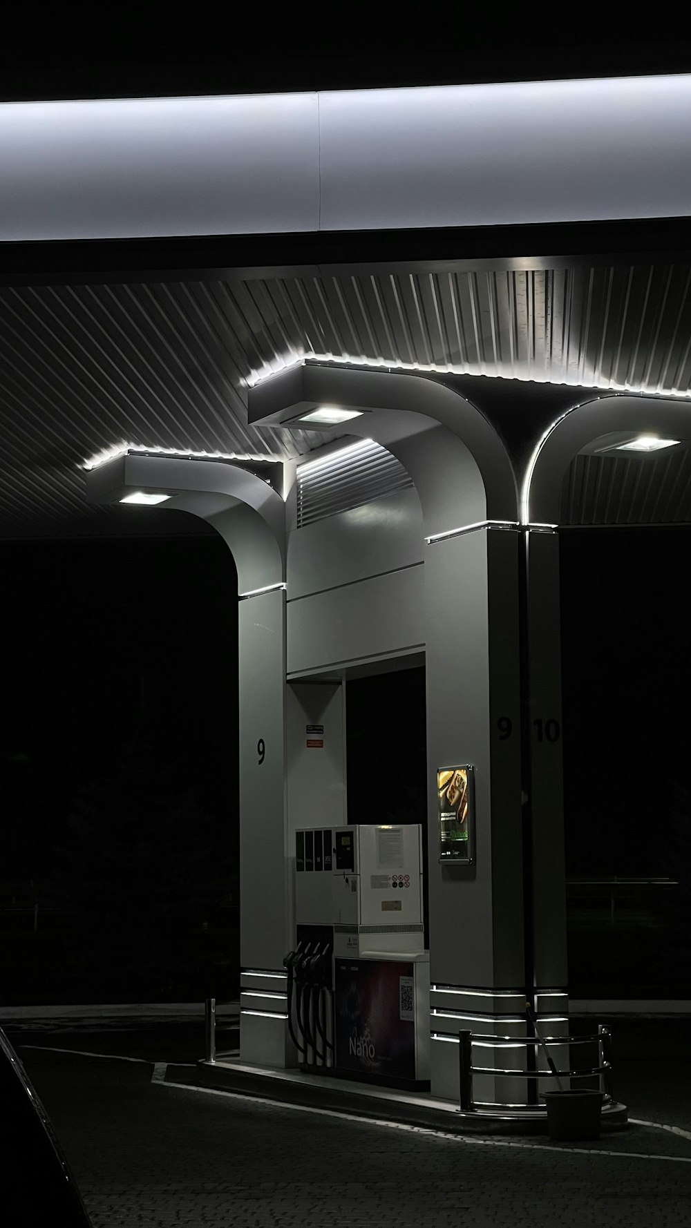 a gas station at night with lights on