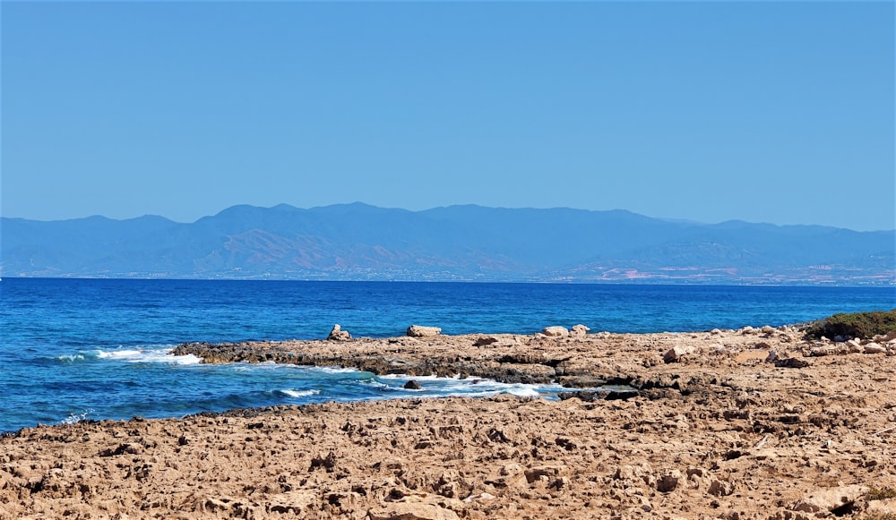 a view of the ocean with mountains in the background