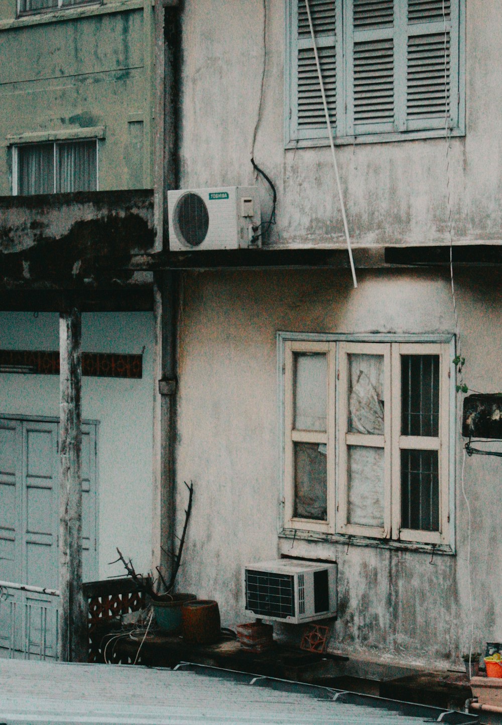 an old building with a window and air conditioner