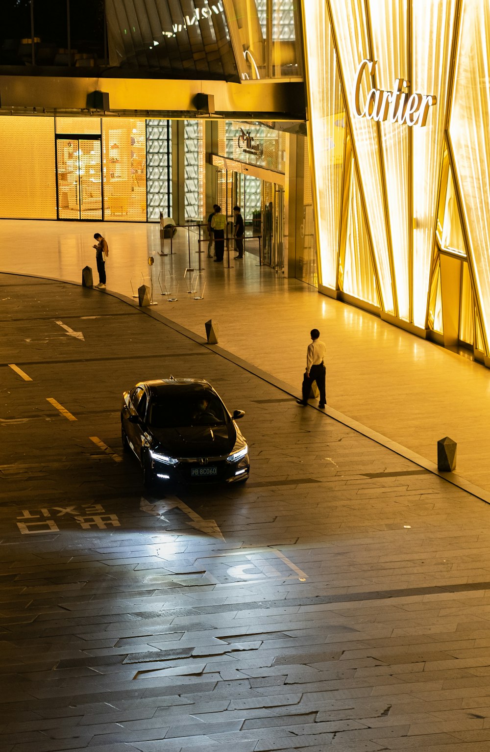 a car parked in front of a building at night