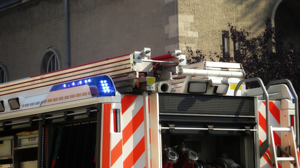 a fire truck with its lights on is parked in front of a building