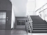 Home elevator elegantly integrated into a modern residential staircase.