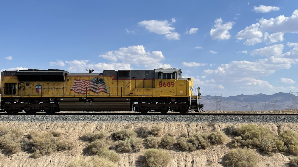 a yellow train with an american flag painted on it