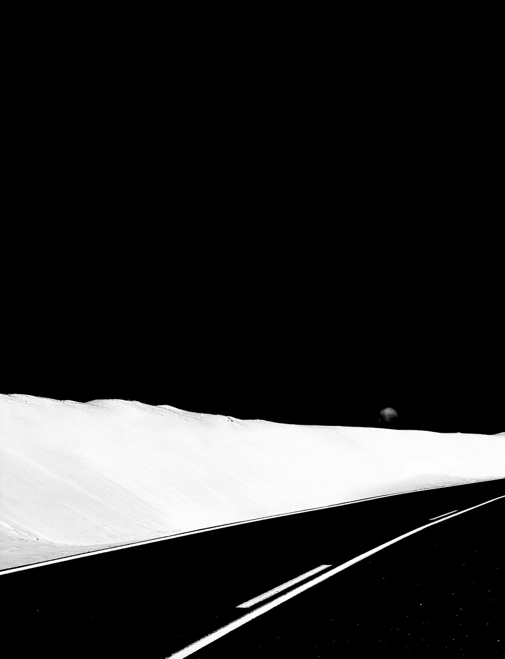 a man riding a snowboard down a snow covered slope