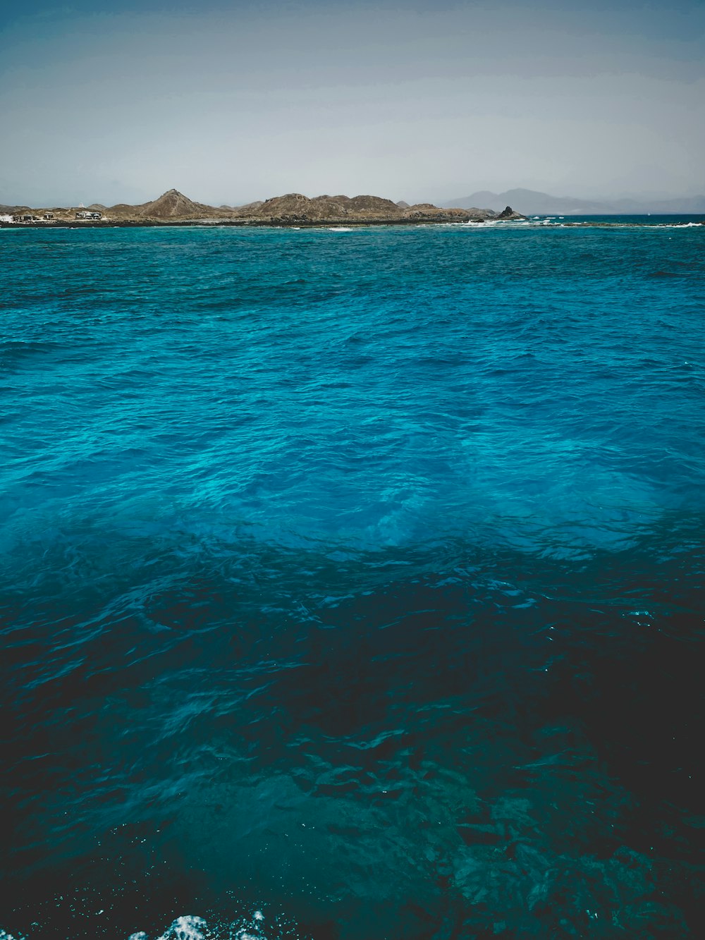 a body of water with a small island in the distance