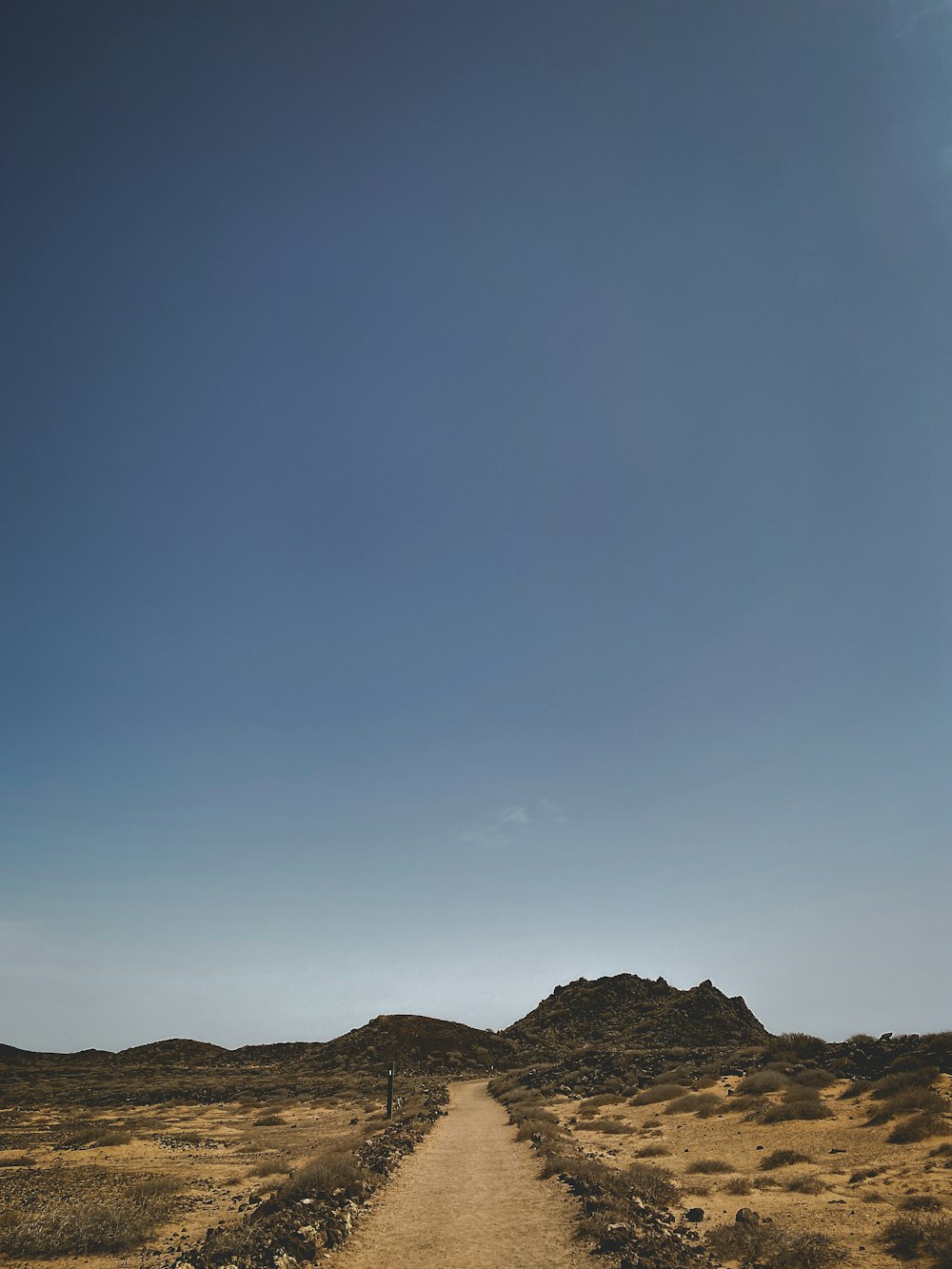 a dirt road in the middle of a desert